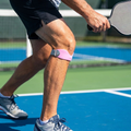 LungeGuard knee strap worn on court by pickleball player